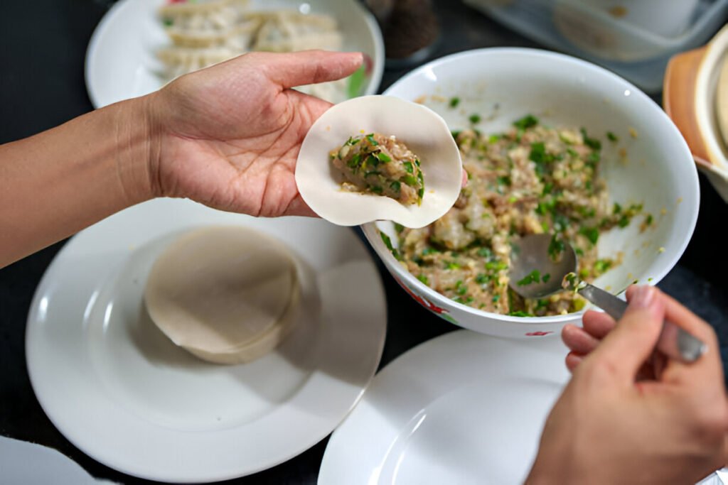 hands making dumplings with fresh ingredients