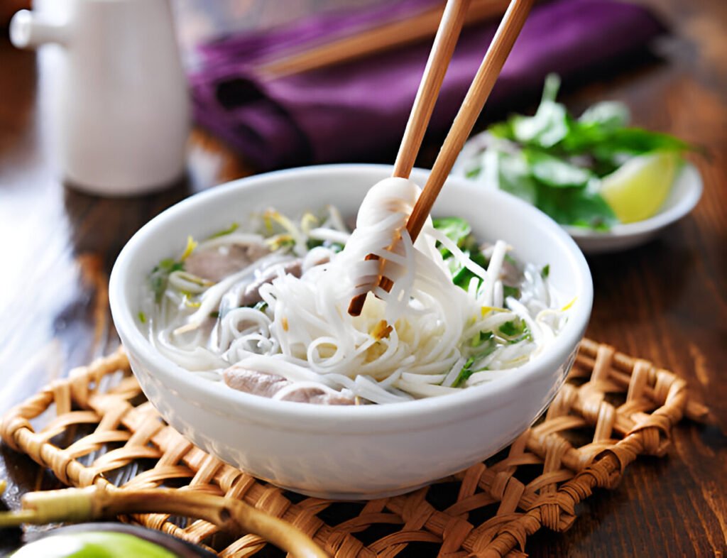 picking up noodles out of a bowl